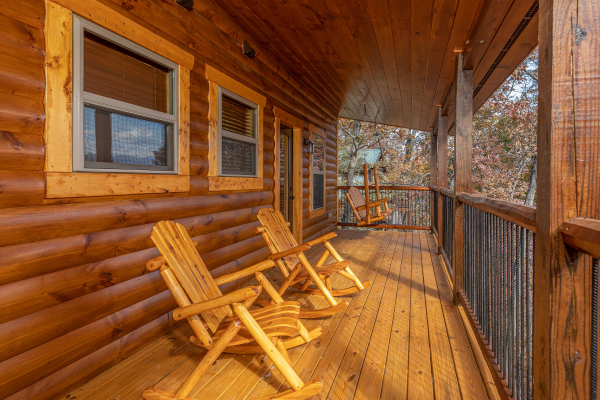 Rocking chairs on the covered upper deck at Pinot Splash, a 4 bedroom cabin rental located in Gatlinburg