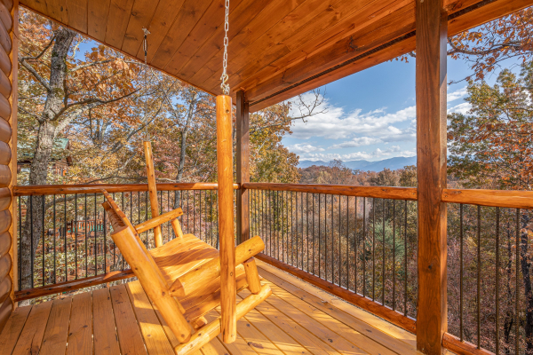 Swing on a covered porch at Pinot Splash, a 4 bedroom cabin rental located in Gatlinburg