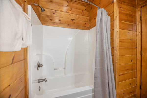 Bathroom with a tub and shower at King of the Mountain, a 3 bedroom cabin rental located in Pigeon Forge