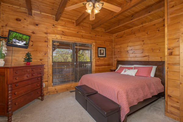 Bedroom with a dresser and TV at King of the Mountain, a 3 bedroom cabin rental located in Pigeon Forge