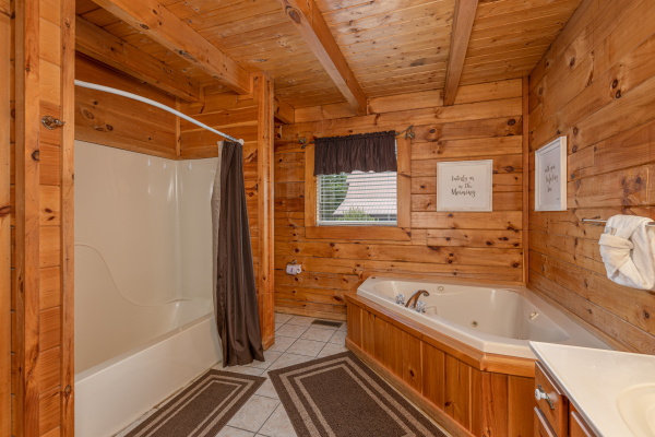 Bathroom with a tub, shower, and jacuzzi at Logged Inn, a 3 bedroom cabin rental located in Pigeon Forge
