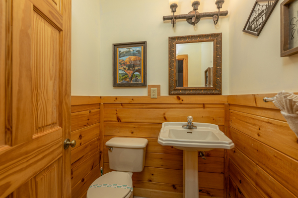 Half bath at Logged Inn, a 3 bedroom cabin rental located in Pigeon Forge