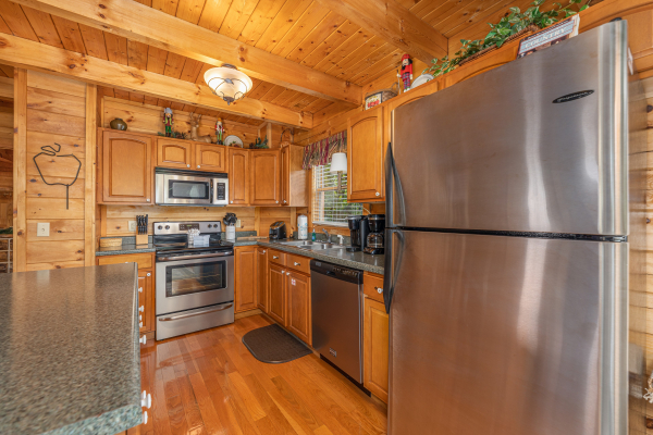 Kitchen with stainless appliances at Logged Inn, a 3 bedroom cabin rental located in Pigeon Forge