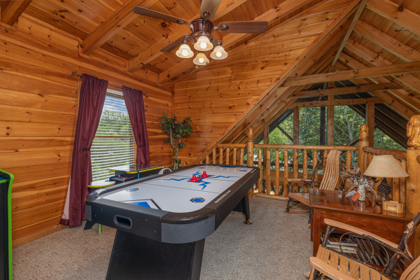 Loft with an air hockey table at Logged Inn, a 3 bedroom cabin rental located in Pigeon Forge