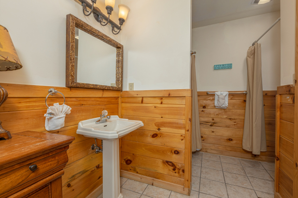 Bathroom with a pedestal sink at Logged Inn, a 3 bedroom cabin rental located in Pigeon Forge