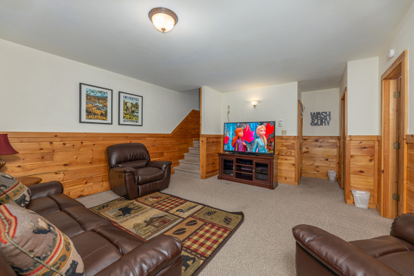 Living room with TV at Logged Inn, a 3 bedroom cabin rental located in Pigeon Forge