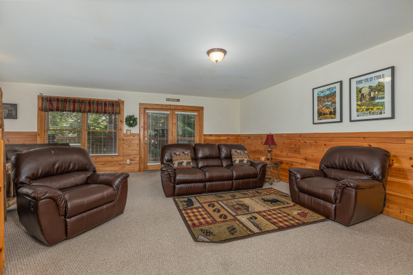 Sofa and two oversized chairs in a living room at Logged Inn, a 3 bedroom cabin rental located in Pigeon Forge