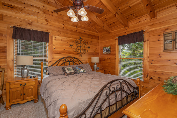 Bedroom with two night stands, lamps, and a dresser at Logged Inn, a 3 bedroom cabin rental located in Pigeon Forge