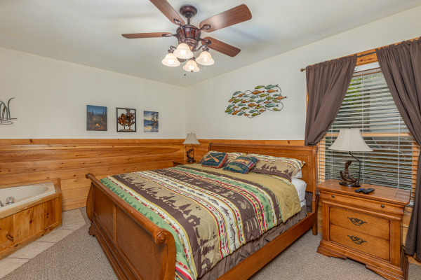 Bedroom with sleigh bed, night stands, and lamps at Logged Inn, a 3 bedroom cabin rental located in Pigeon Forge