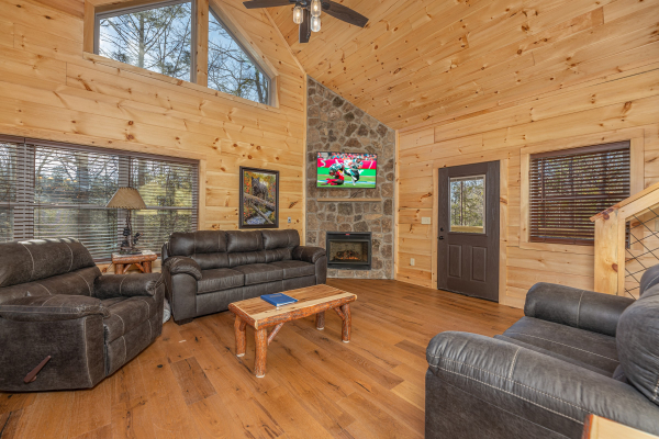 Vaulted living room with fireplace and TV at Bessy Bears Cabin, a 2 bedroom cabin rental located inGatlinburg