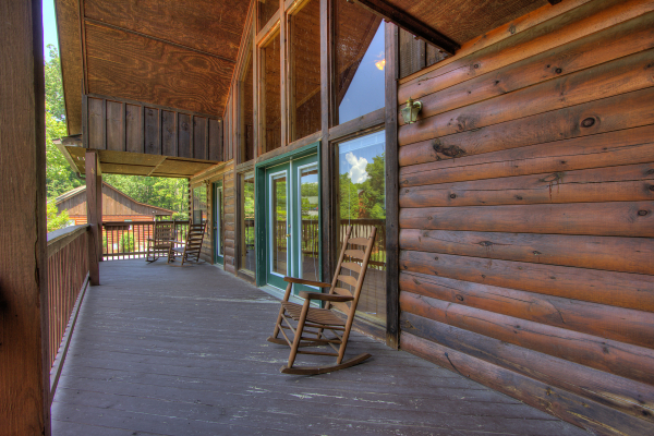 Rocking chairs on the upper deck at Pool Side Lodge, a 6 bedroom cabin rental located in Pigeon Forge