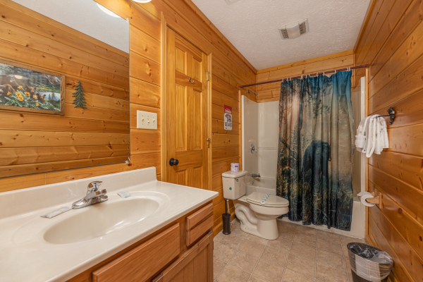 Bathroom with a tub and shower at Pool Side Lodge, a 6 bedroom cabin rental located in Pigeon Forge