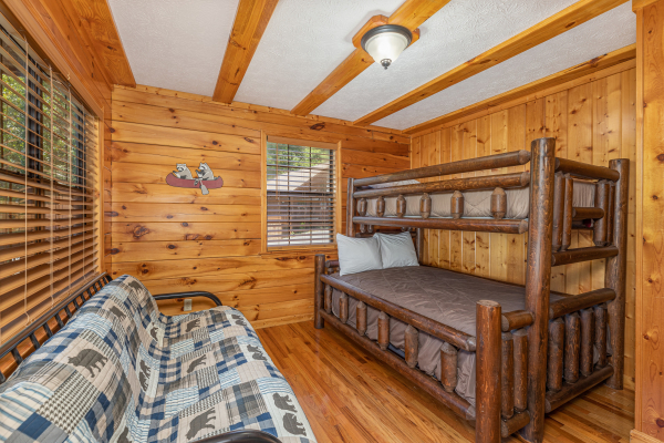 Bedroom with a futon and bunk beds at Pool Side Lodge, a 6 bedroom cabin rental located in Pigeon Forge