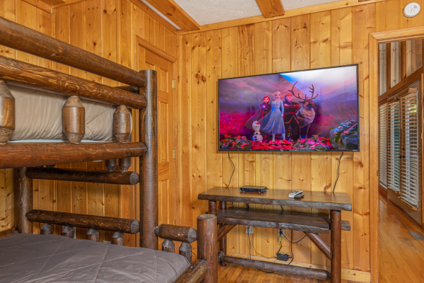 TV and console table in a bedroom at Pool Side Lodge, a 6 bedroom cabin rental located in Pigeon Forge