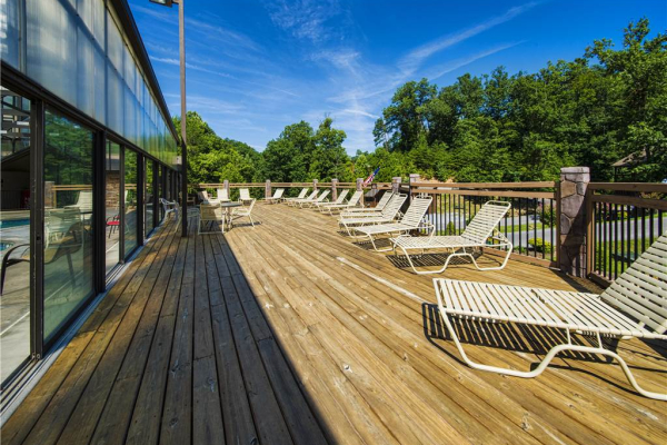 Pool deck for guests at Pool Side Lodge, a 6 bedroom cabin rental located in Pigeon Forge