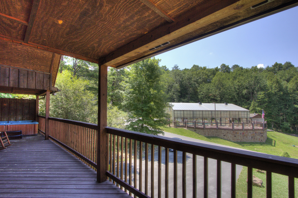 Hot tub deck with a view of the indoor pool at Pool Side Lodge, a 6 bedroom cabin rental located in Pigeon Forge