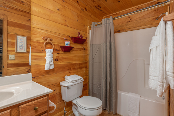 Bathroom with a tub and shower at A Cheerful Heart, a 2 bedroom cabin rental located in Pigeon Forge