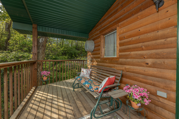Deck with a bench at A Cheerful Heart, a 2 bedroom cabin rental located in Pigeon Forge