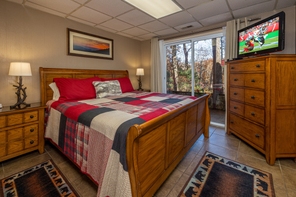 Bedroom with glass sliding doors at Buena Vista Getaway, a 3 bedroom cabin rental located in gatlinburg