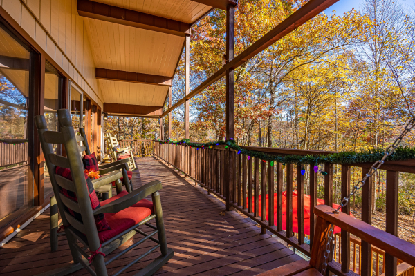Rocking chairs under covered deck at Buena Vista Getaway, a 3 bedroom cabin rental located in gatlinburg