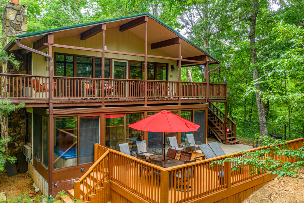 Side exterior with deck seating and outdoor eating area at Buena Vista Getaway, 3 bedroom cabin rental located in Gatlinburg