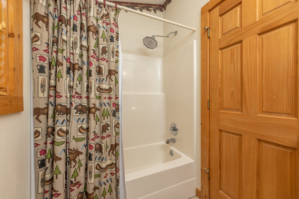 Bathroom with a tub and shower at Cub's Crossing, a 3 bedroom cabin rental located in Gatlinburg