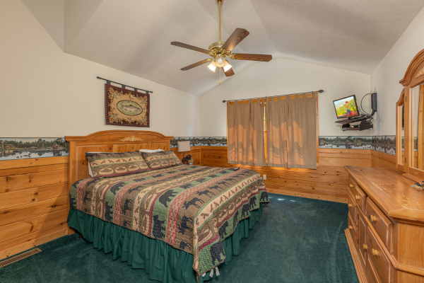 Bedroom with a queen bed, TV, and dresser at Cub's Crossing, a 3 bedroom cabin rental located in Gatlinburg