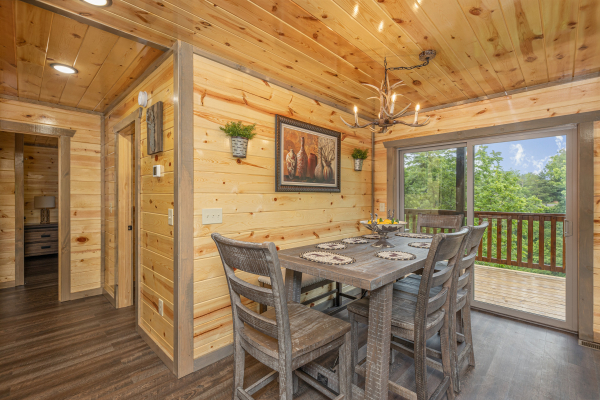 Dining table for four at Alpine Adventure, a 4 bedroom cabin rental located in Pigeon Forge