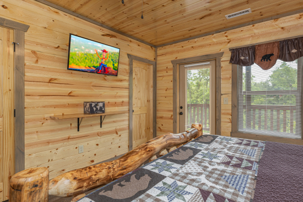 TV and deck access in a bedroom at Alpine Adventure, a 4 bedroom cabin rental located in Pigeon Forge