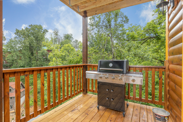 Grill on a covered deck at Alpine Adventure, a 4 bedroom cabin rental located in Pigeon Forge