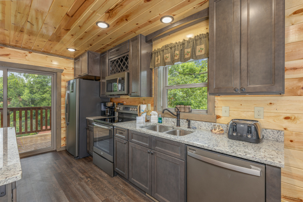 Kitchen with stainless appliances at Alpine Adventure, a 4 bedroom cabin rental located in Pigeon Forge