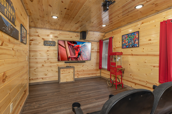 Theater room screen at Alpine Adventure, a 4 bedroom cabin rental located in Pigeon Forge