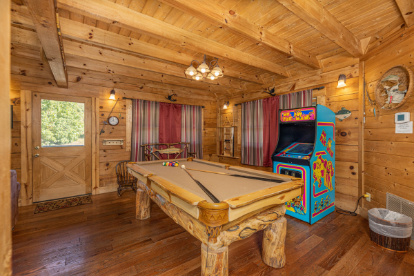 Pool table and arcade game at A Beary Nice Cabin, a 2 bedroom cabin rental located in Pigeon Forge