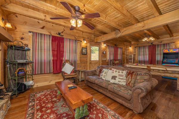 Living room and game room at A Beary Nice Cabin, a 2 bedroom cabin rental located in Pigeon Forge