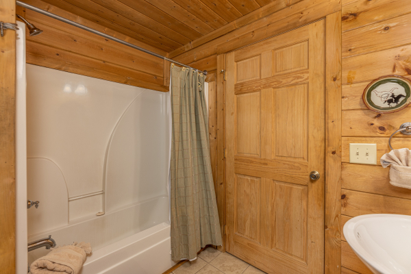 Tub and shower in a bathroom at A Beary Nice Cabin, a 2 bedroom cabin rental located in Pigeon Forge