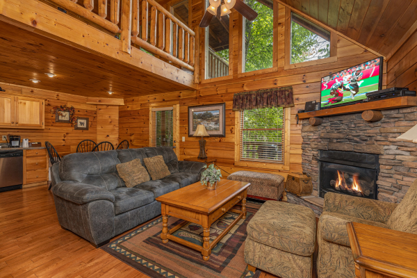 Living room with fireplace and TV at Bearway to Heaven, a 2 bedroom cabin rental located in Gatlinburg