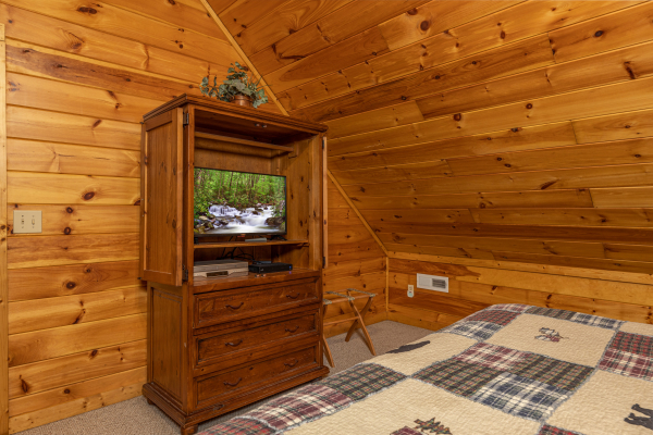 TV and armoire in a bedroom at Bearway to Heaven, a 2 bedroom cabin rental located in Gatlinburg