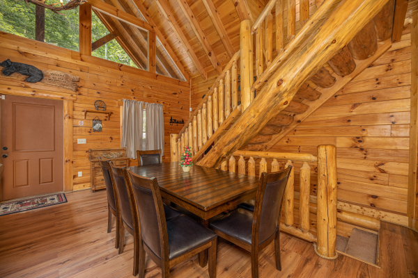 Dining space for eight at King Wolf Lodge, a 3 bedroom cabin rental located in Pigeon Forge