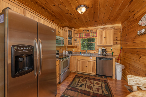 Kitchen with stainless appliances at King Wolf Lodge, a 3 bedroom cabin rental located in Pigeon Forge