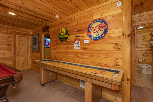 Shuffle board game at King Wolf Lodge, a 3 bedroom cabin rental located in Pigeon Forge