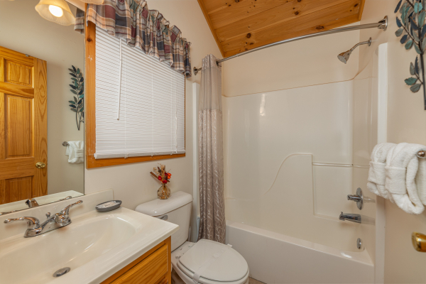 Bathroom with a tub and shower at Honeysuckle Hideaway, a 1 bedroom cabin rental located in Pigeon Forge