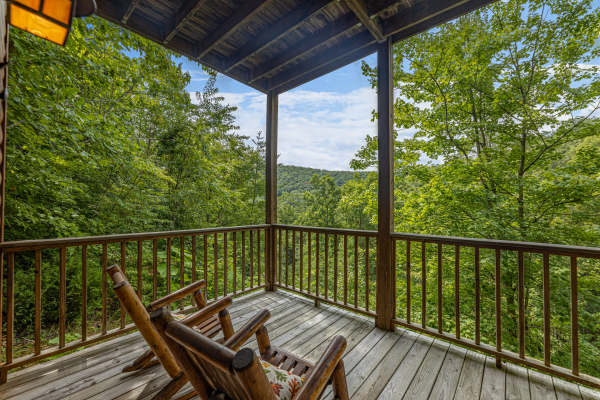 Wooded porch view at Honeysuckle Hideaway, a 1 bedroom cabin rental located in Pigeon Forge