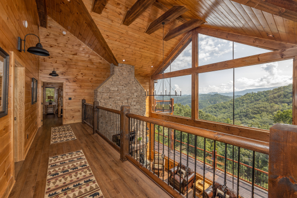 Upstairs catwalk with large windows at Black Bears & Biscuits Lodge, a 6 bedroom cabin rental located in Pigeon Forge