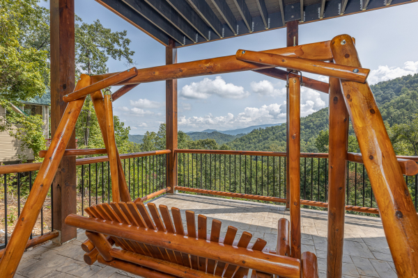 Deck swing at Black Bears & Biscuits Lodge, a 6 bedroom cabin rental located in Pigeon Forge