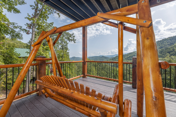 Deck swing at Black Bears & Biscuits Lodge, a 6 bedroom cabin rental located in Pigeon Forge