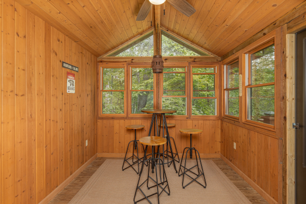 Sunroom with seating for four at Cubs' Crib, a 3 bedroom cabin rental located in Gatlinburg