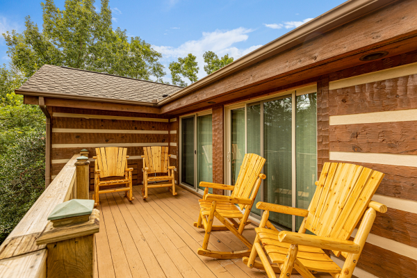 Deck with four rocking chairs at Cubs' Crib, a 3 bedroom cabin rental located in Gatlinburg