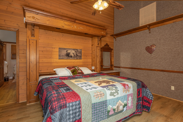 King bed and night stand at Cubs' Crib, a 3 bedroom cabin rental located in Gatlinburg