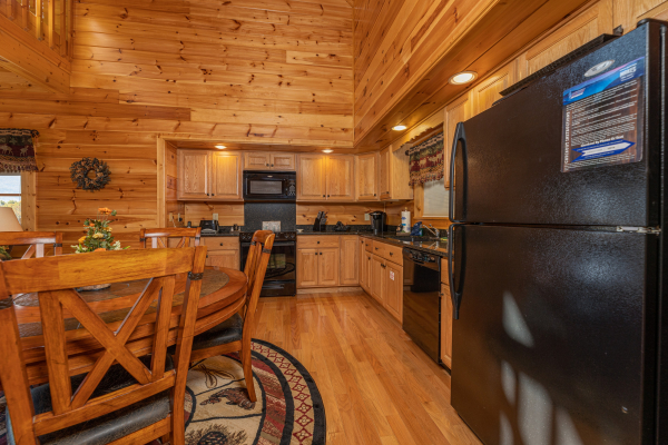 Kitchen and dining table at Sensational Views, a 3 bedroom cabin rental located in Gatlinburg