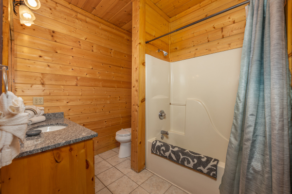 Bathroom with a tub and shower at Grizzly's Den, a 5 bedroom cabin rental located in Gatlinburg